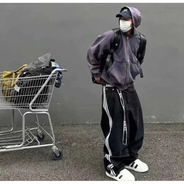 Black side-stripe trousers shown in the linked Balenciaga catalog listing
