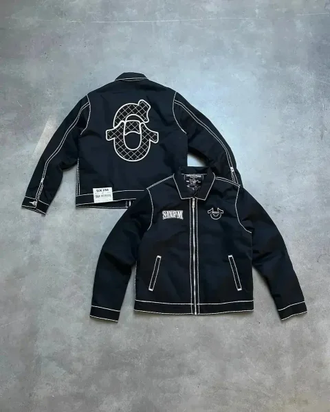 Black contrast-stitch jacket shown in the linked True Religion catalog listing