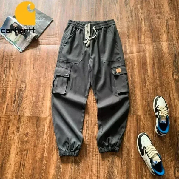 Dark cargo pants shown in the linked Carhartt catalog listing