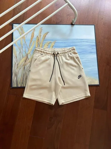 Beige drawstring shorts shown in the linked Nike catalog listing