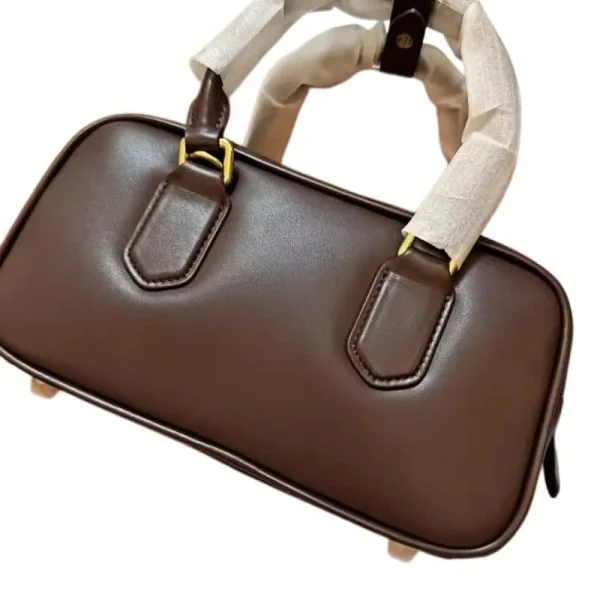 Brown top-handle bag shown in the linked Gucci catalog listing