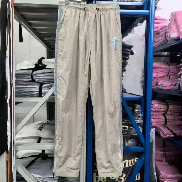 Beige track pants shown in the linked Represent catalog listing
